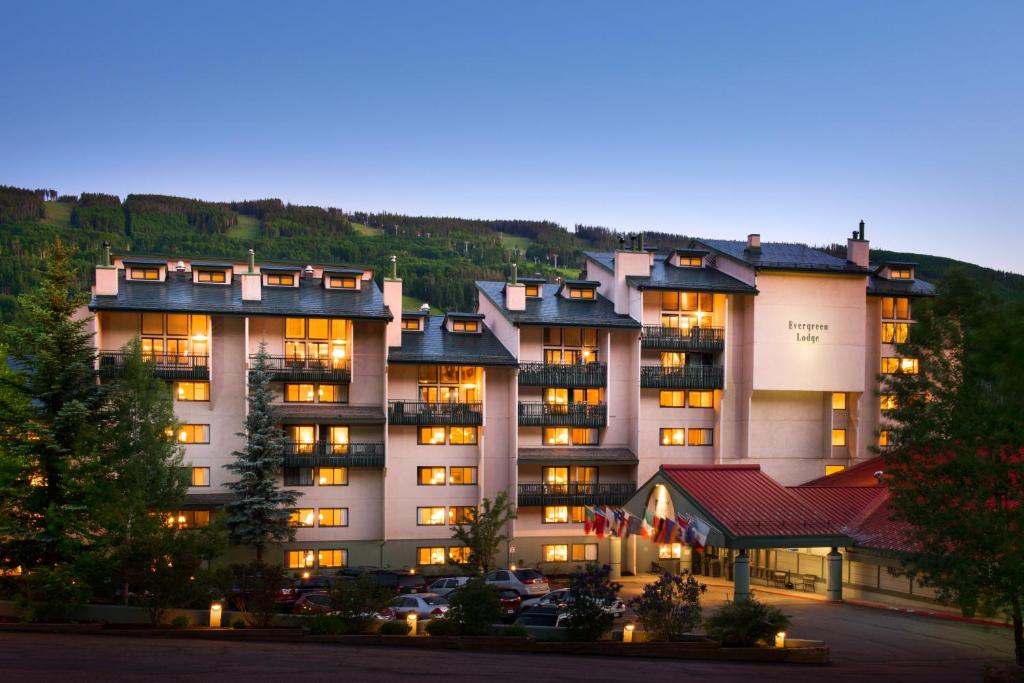 a large building with cars parked in a parking lot at Evergreen Lodge at Vail in Vail