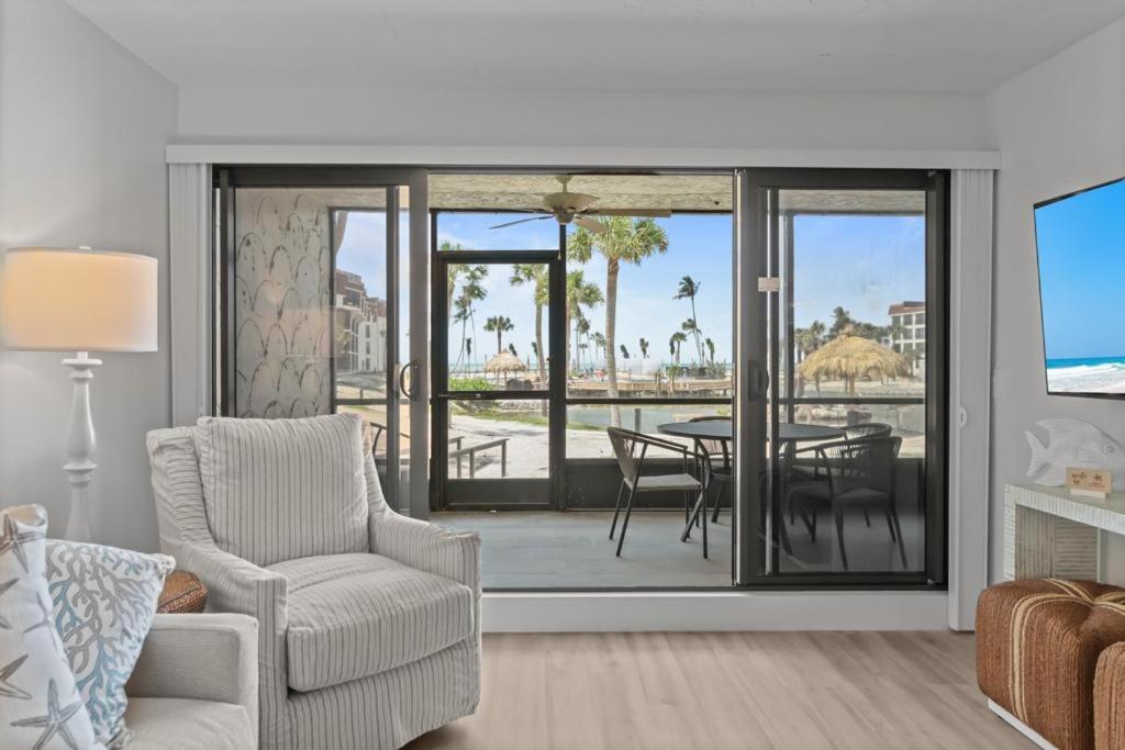 a living room with a couch and a chair and a table at Pointe Santo C1 in Sanibel