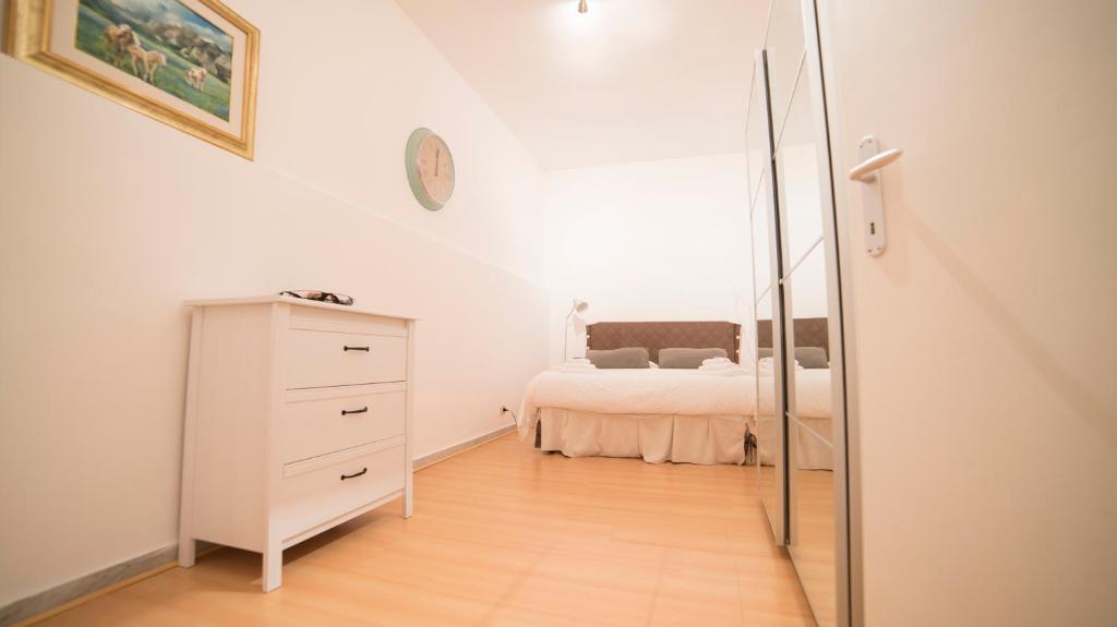 a bedroom with a bed and a dresser and a mirror at Youroom Corsini in Rome