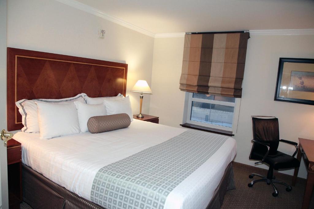 Postel nebo postele na pokoji v ubytování Hotel Executive Suites