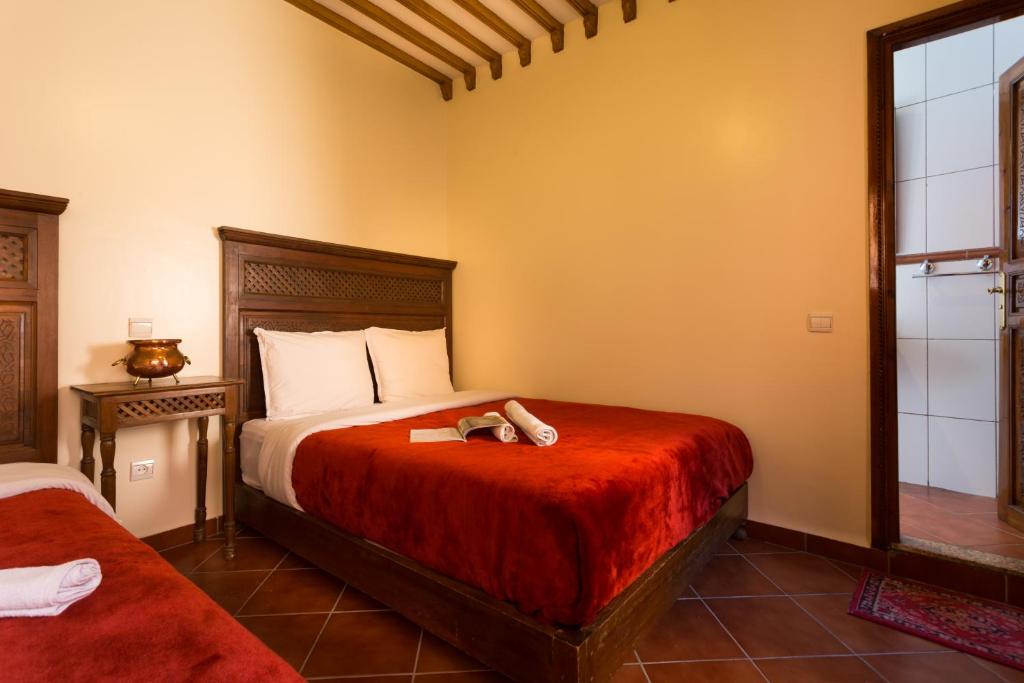 Cama o camas de una habitación en Hotel Atlas