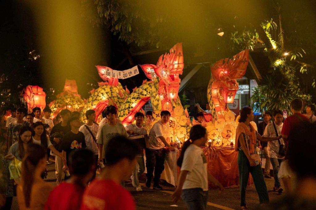 a crowd of people standing in front of a fair at Golden Lotus Namkhan View in Luang Prabang