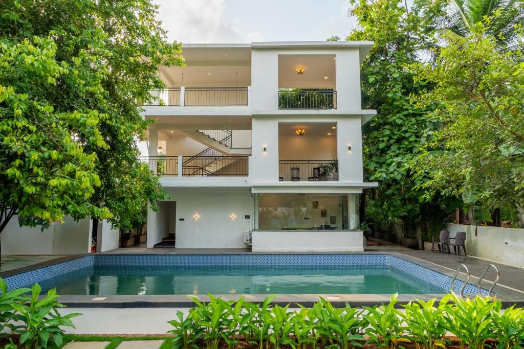 an apartment building with a swimming pool in front of it at Mysa by De Soul Santé in Morjim