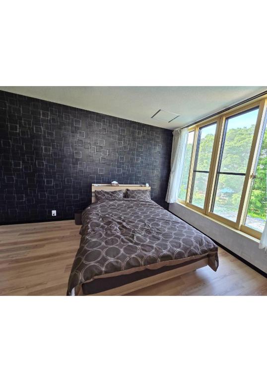 a large bed in a room with a large window at T&T Fujiyama MC2 in Iiyama