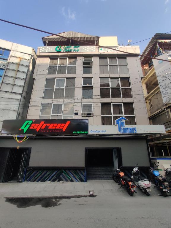 a building with two motorcycles parked in front of it at Treebo Terminus, Koramangala 5th Block in Bangalore