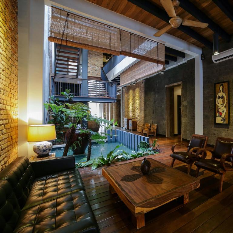 a living room with a couch and a table at 1825 Gallery Hotel in Melaka