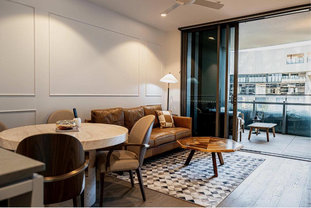 a living room with a couch and a table at Riverside Reverie French Luxury at BNE Casino in Brisbane