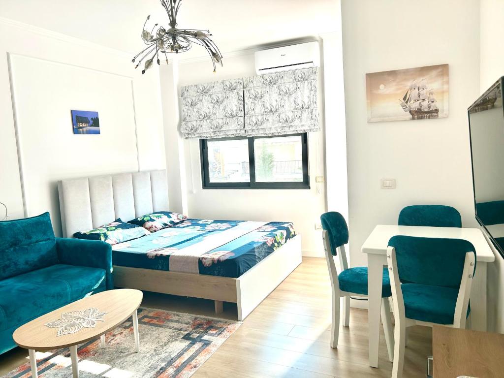 a bedroom with a bed and a couch and a table at Besmir's in Golem