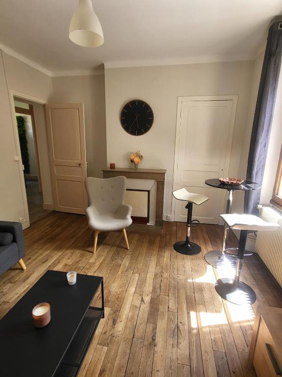 a living room with a table and a chair at Cozy Zen de Paray 2 bedroom in Paray-le-Monial