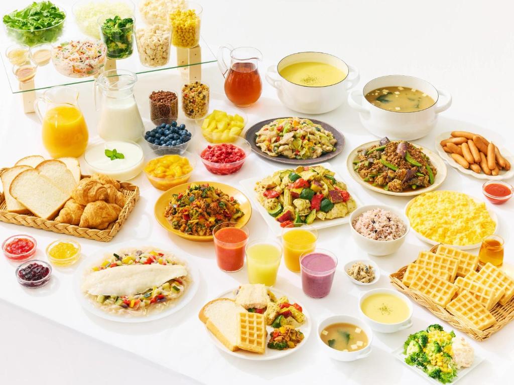 a table filled with different types of food at Comfort Hotel Tokyo Kanda in Tokyo