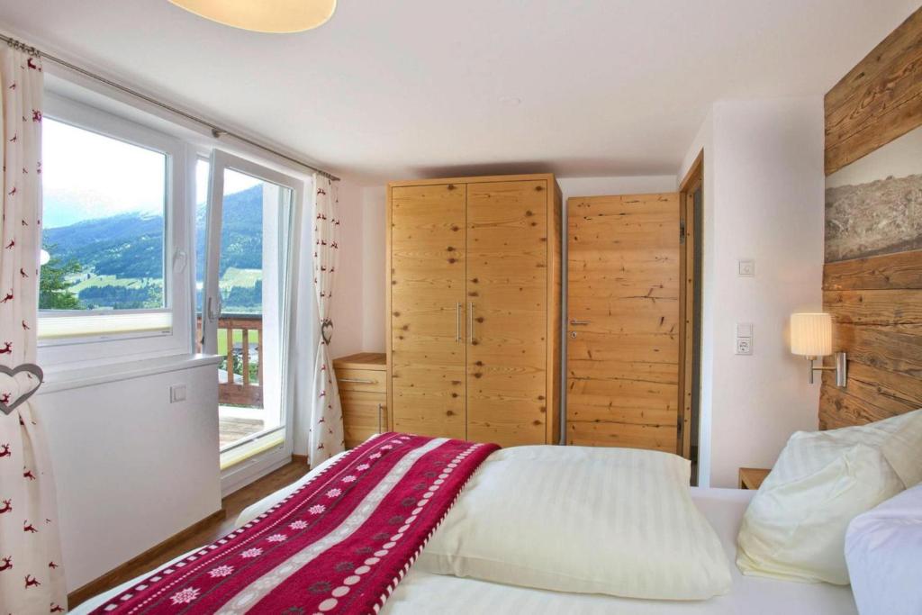 A bed or beds in a room at Apartment in Neukirchen with a balcony