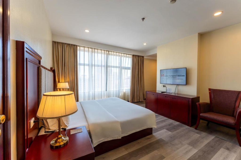 Postel nebo postele na pokoji v ubytování Swiss-Belhotel Blulane