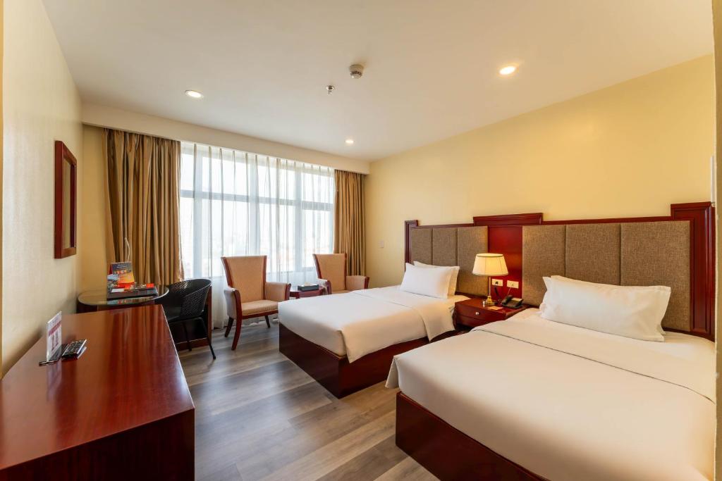 Postel nebo postele na pokoji v ubytování Swiss-Belhotel Blulane