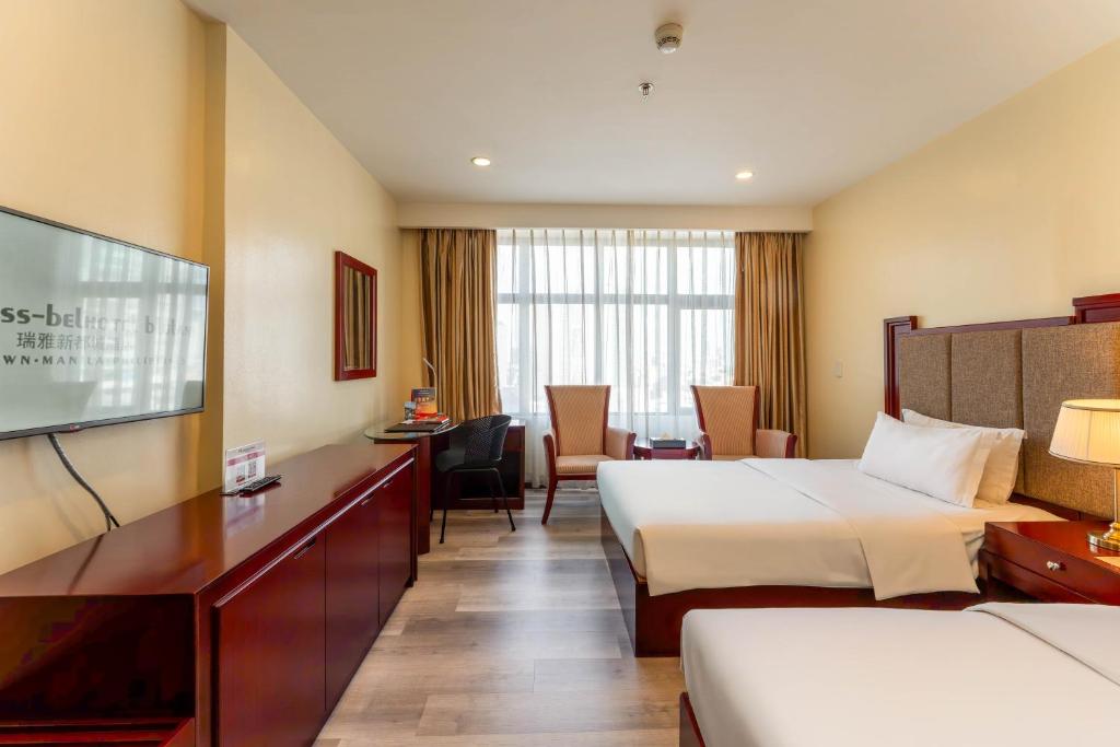 Postel nebo postele na pokoji v ubytování Swiss-Belhotel Blulane