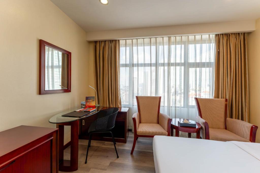 Postel nebo postele na pokoji v ubytování Swiss-Belhotel Blulane
