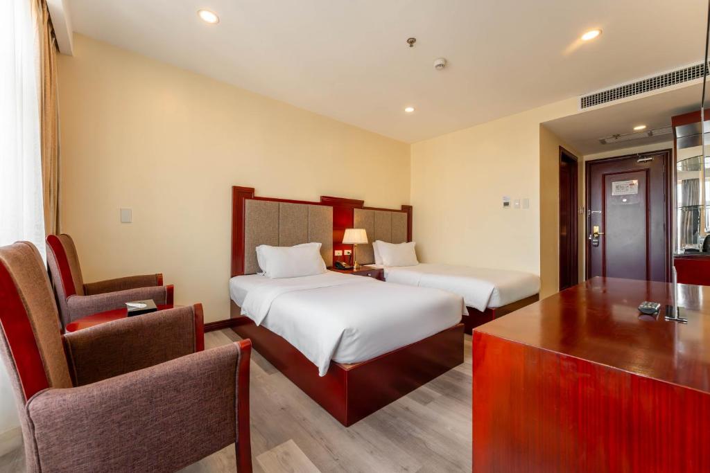 Postel nebo postele na pokoji v ubytování Swiss-Belhotel Blulane