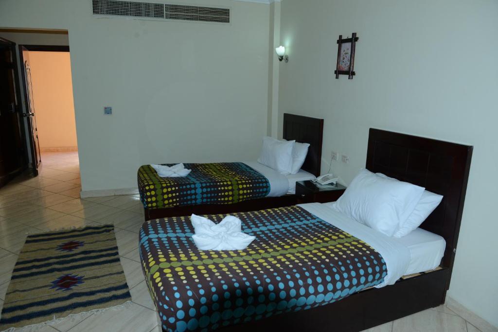 A bed or beds in a room at La Sirena Hotel & Resort - Families only