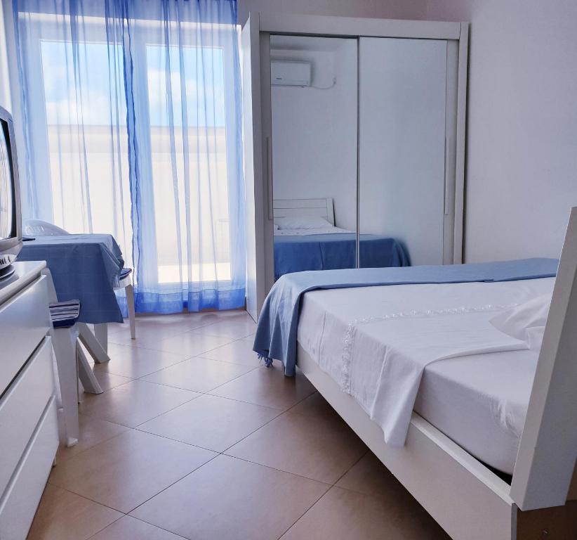 a bedroom with two beds and a tv in it at Apartment Lana Maris studio 2 - 200m from beach, terrace with sea view, wi-fi and free parking in Dramalj