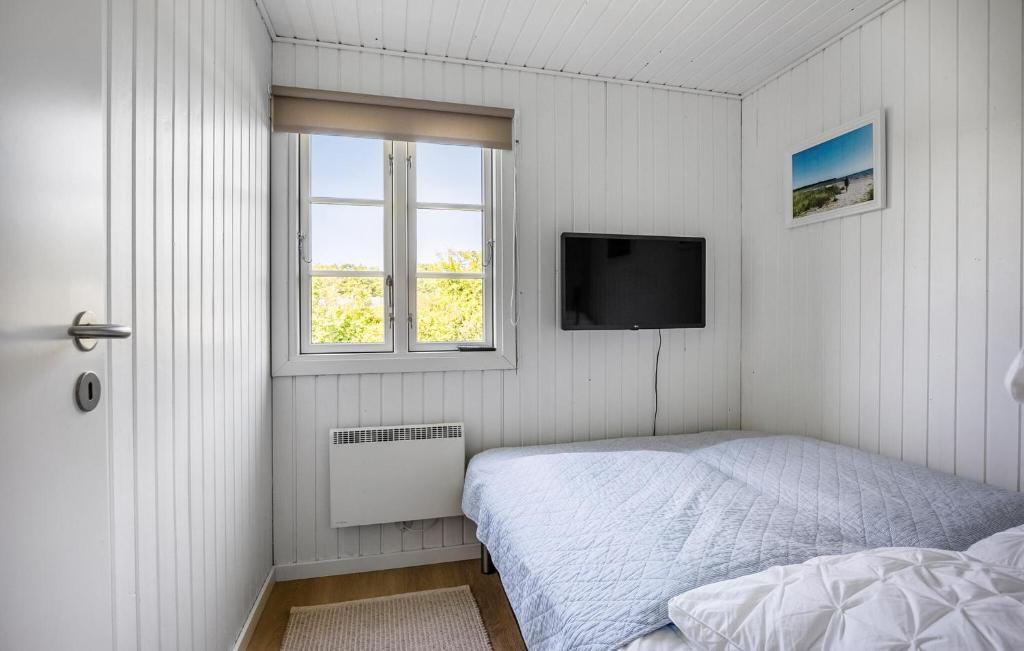 a white bedroom with a bed and a television at Nice Home In Haderslev With Wifi in Haderslev