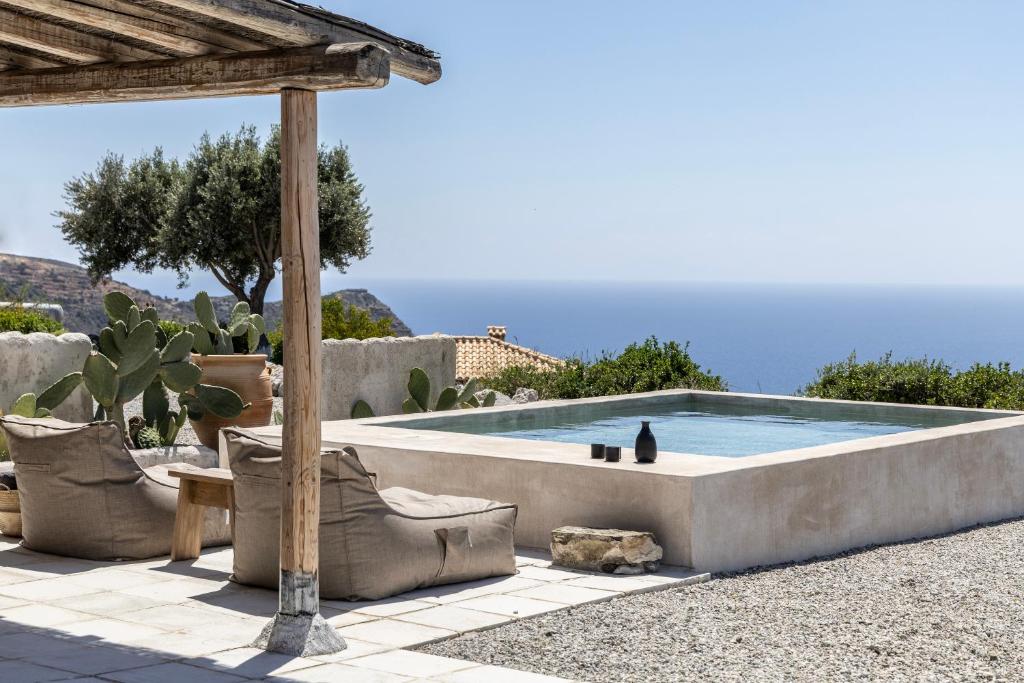 a swimming pool in the middle of a patio at Palazzo Greco Villas in Agia Galini