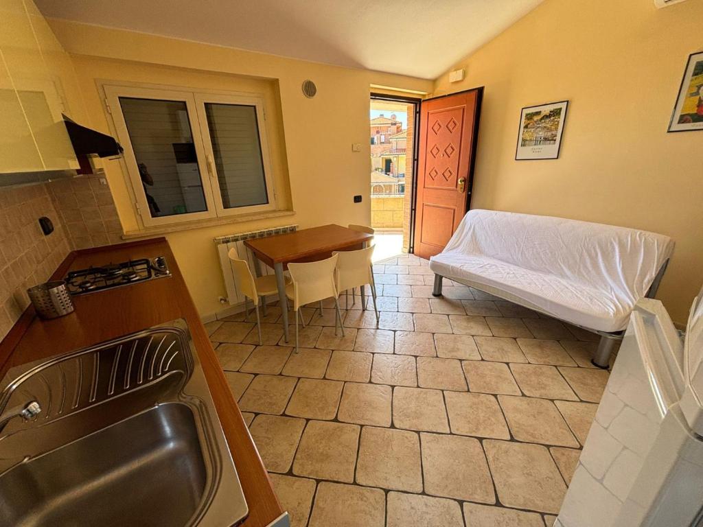 a kitchen with a bed and a table with a tableablish at Residence IL BORGO 38 in Tortoreto Lido