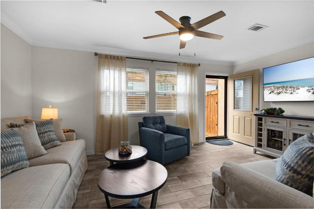 a living room with a couch and a ceiling fan at Beach Rendezvous in Navarre