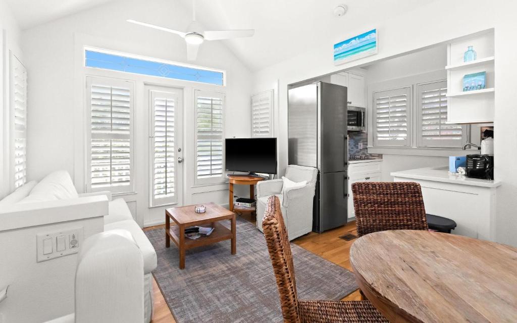 a living room with a table and a kitchen at Spice in Santa Rosa Beach