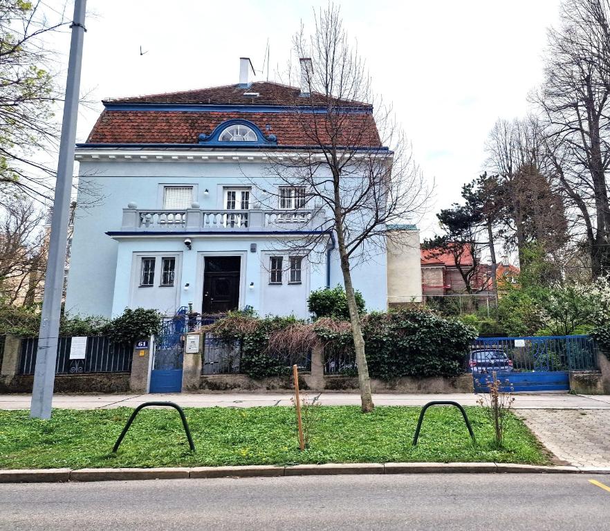 a white house with a red roof on a street at CALM & GREEN by JR City Apartments in Vienna