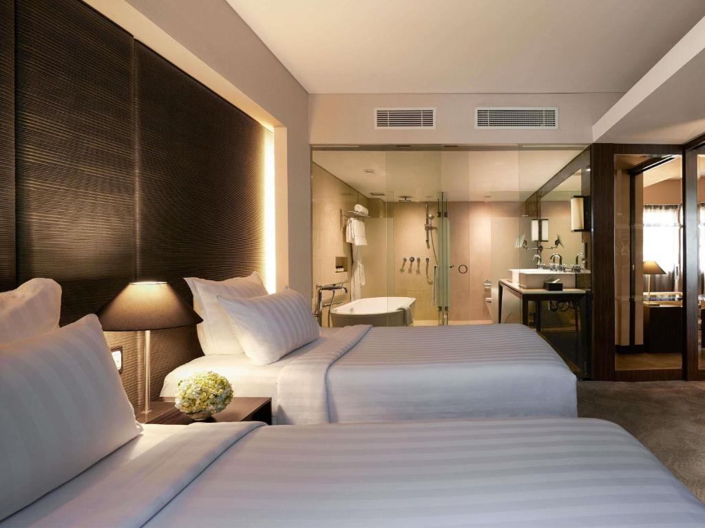 Postel nebo postele na pokoji v ubytování Pullman Jakarta Indonesia