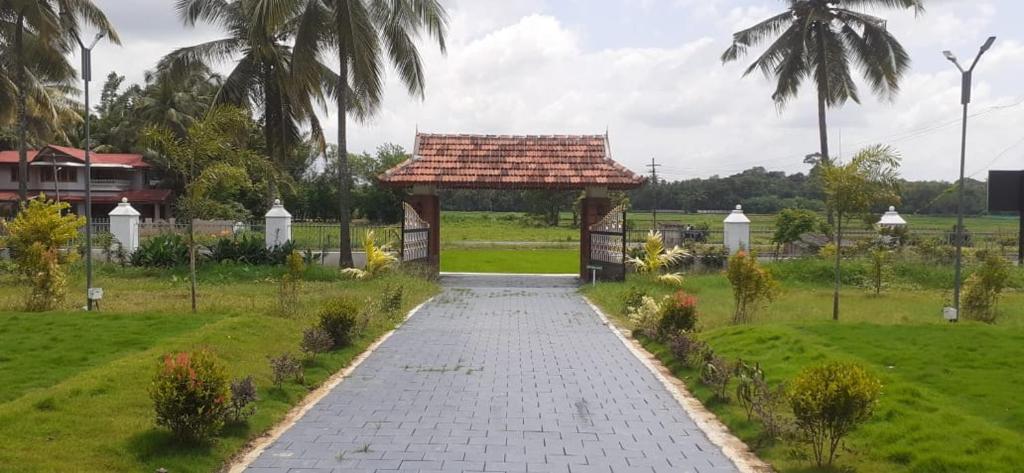 a walkway leading to a gazebo in a park at Chithrapuri Heritage Hotels Pvt Ltd in Alattūr
