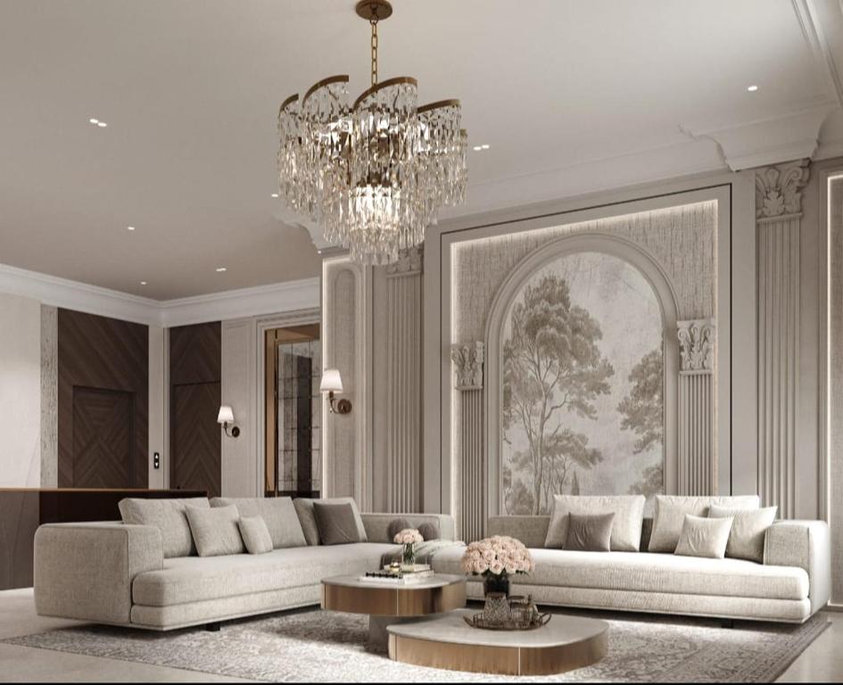 Vip Apartment Near Marriot في Mekhrably: غرفة معيشة بها كنبتين وثريا
