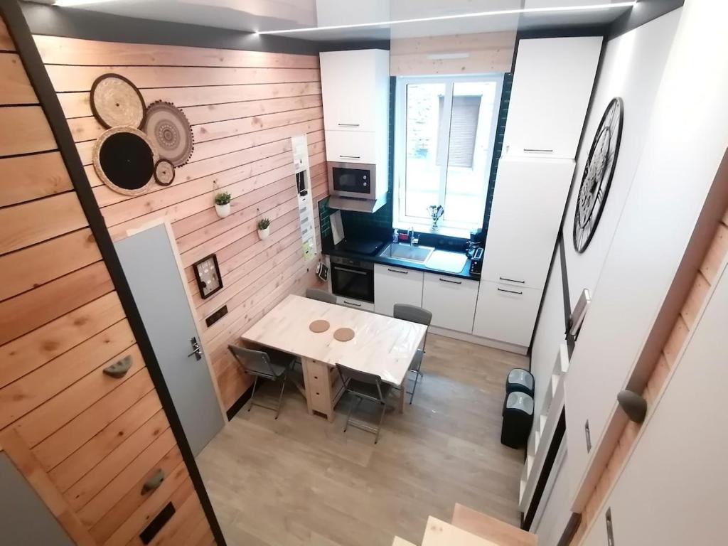 a small kitchen with a table in a room at Petit cocon centre MONT DORE in Le Mont-Dore