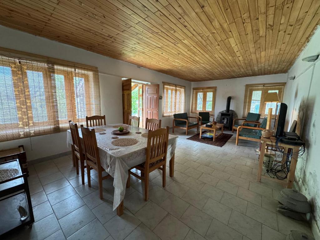 a dining room with a table and chairs at The Walnut Tree Lodge, Naltar in Jugut