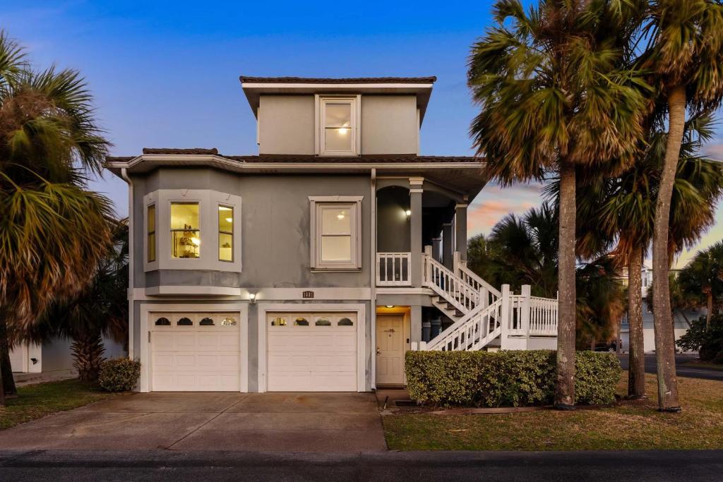 a house with palm trees in front of it at When the Sun Goes Down in Navarre