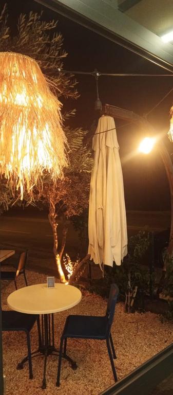 a table and a umbrella and a table and chairs at Port Hotel, Tasucu in Silifke