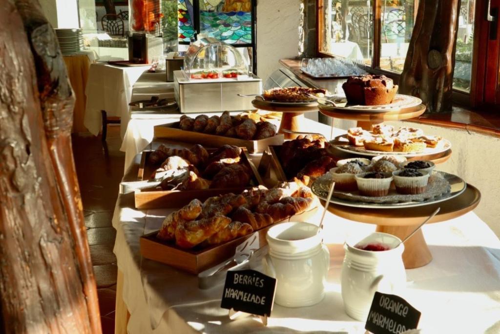 a buffet of pastries and desserts on a table at Hotel Don Diego in Porto San Paolo