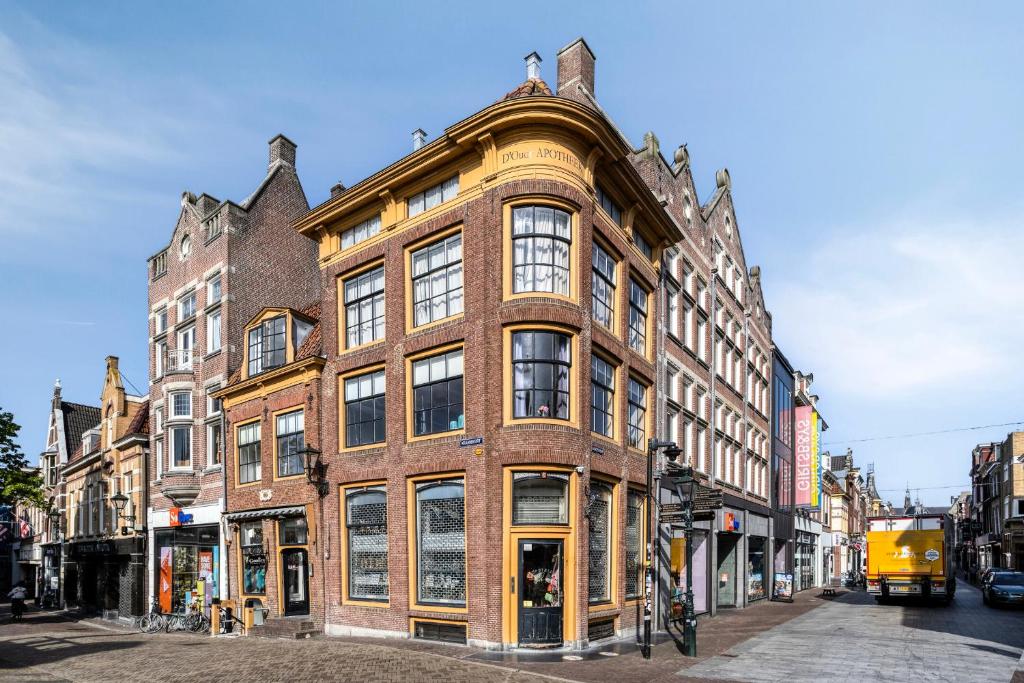 a large brick building on the corner of a street at Authentic apartment in Alkmaar in Alkmaar