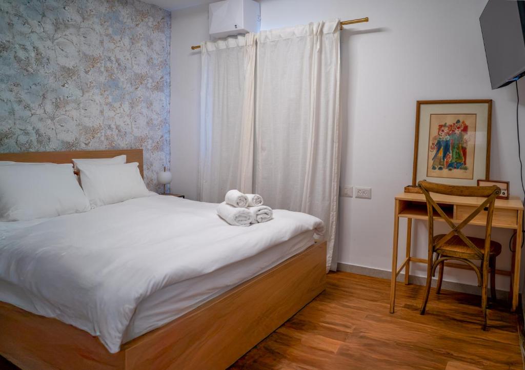 Postel nebo postele na pokoji v ubytování Ha Meyasdim 51