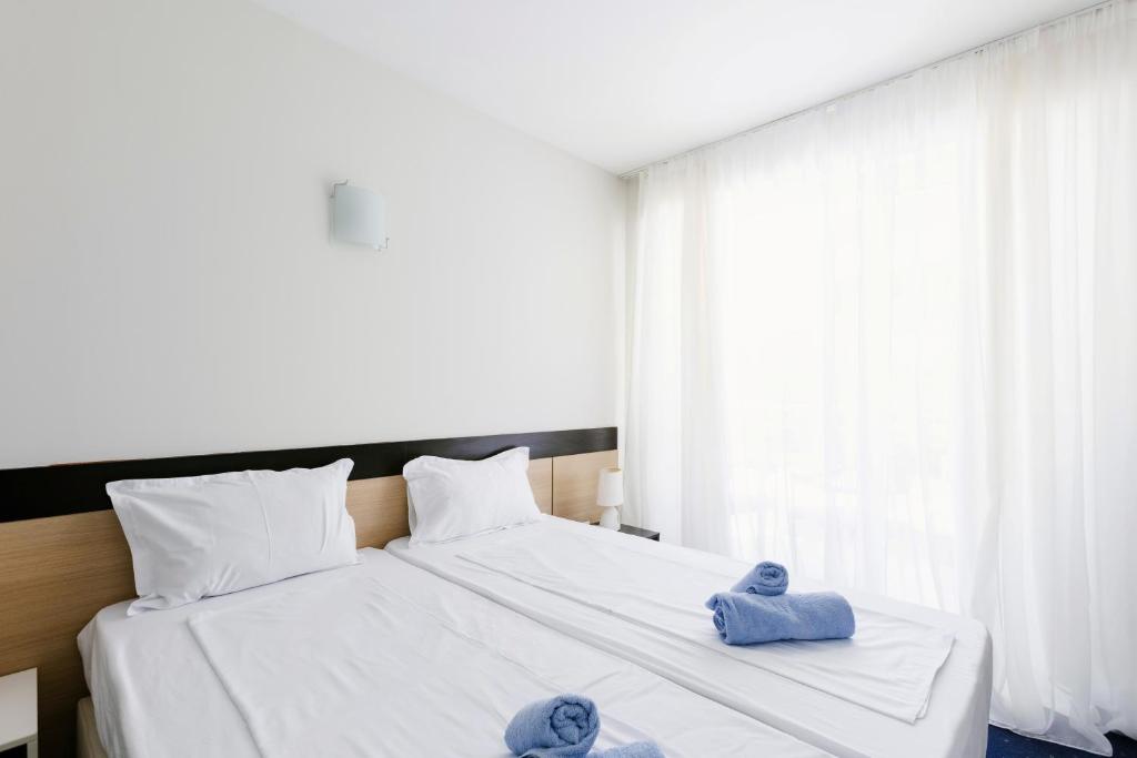 Postel nebo postele na pokoji v ubytování APOLONIS hotel