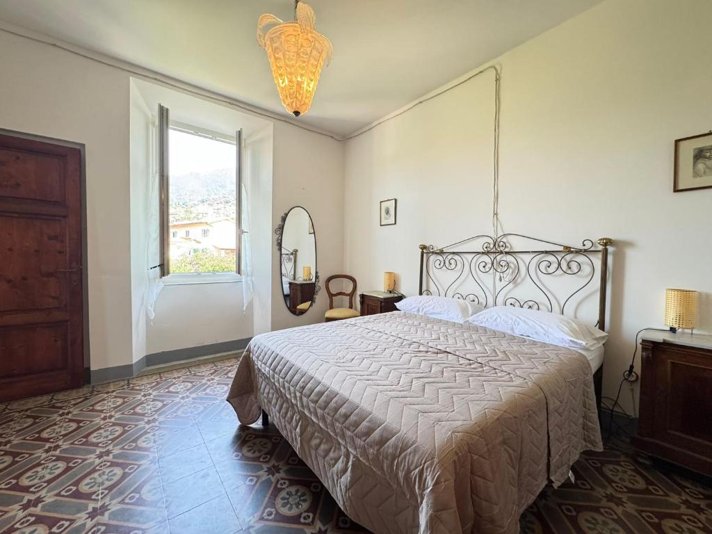 a bedroom with a large bed and a window at casa vacanze La Versilia in Vallecchia