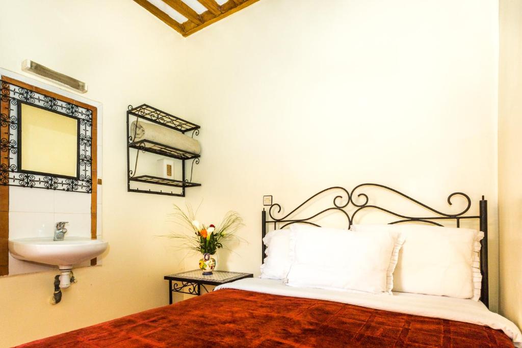Cama o camas de una habitación en Hotel Atlas