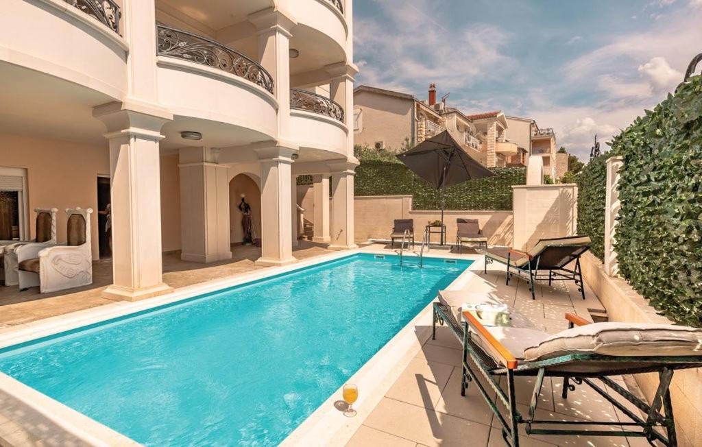 a swimming pool in the middle of a house at Vila Chiara in Makarska