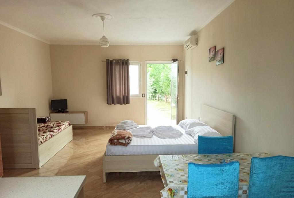 a bedroom with a bed with a dog laying on it at Villa Gozhina in Durrës