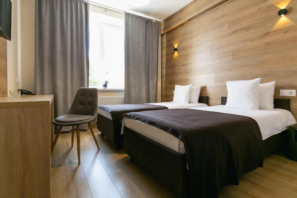 Postel nebo postele na pokoji v ubytování ROCAS Hotel