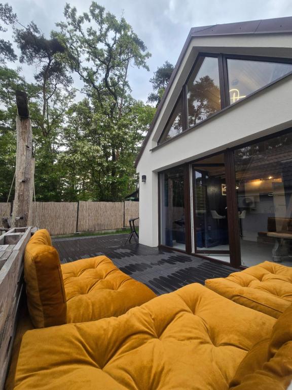 a group of couches sitting on a patio at Stania Glamour CENTRUM in Boszkowo-Letnisko