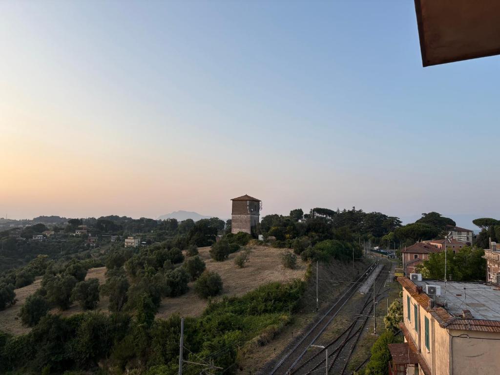 a view of a town with a tower on a hill at Appartamento Veio in Castelnuovo di Porto