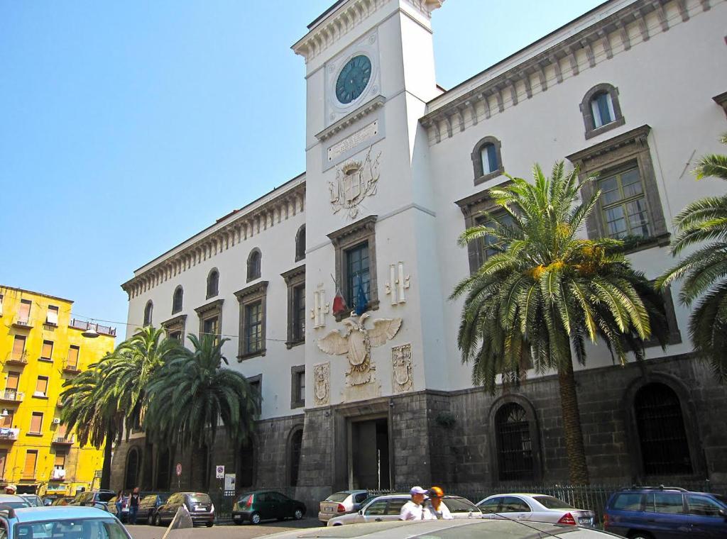 a building with a clock tower on top of it at Tresette Porta Capuana in Naples