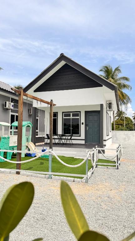 a house with a yard with a house at D'Lamp Studio in Kampung Kuala Besut