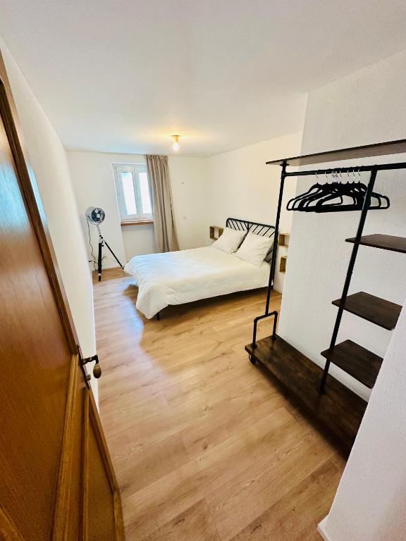 a bedroom with a bed and a staircase in it at Casa Papavero in Gambarogno