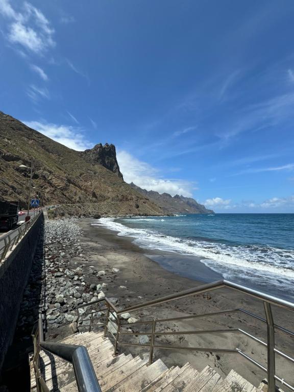 a beach with steps leading down to the ocean at Apartamento junto al mar La Baja in Santa Cruz de Tenerife